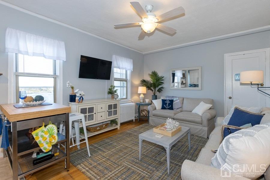 400 Deal Lake Drive, Unit 4G Asbury Park, NJ 07712 - Photo 8 of 20 a living room with furniture a flat screen tv and a window