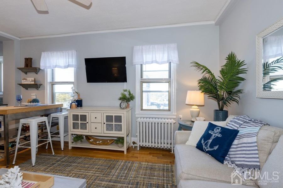 400 Deal Lake Drive, Unit 4G Asbury Park, NJ 07712 - Photo 9 of 20 a living room with furniture and a flat screen tv