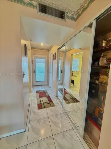 a kitchen with a refrigerator and cabinets