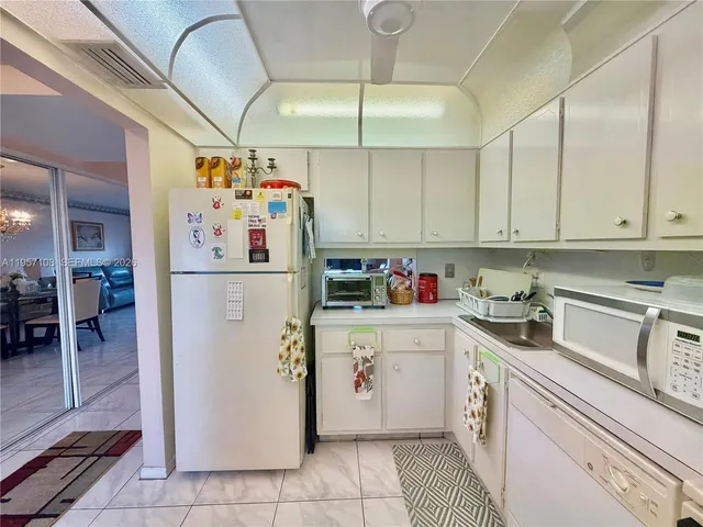 a kitchen with stainless steel appliances a stove a sink and cabinets