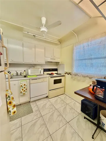 a kitchen with a sink cabinets and window