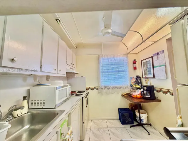 a kitchen with refrigerator and cabinets