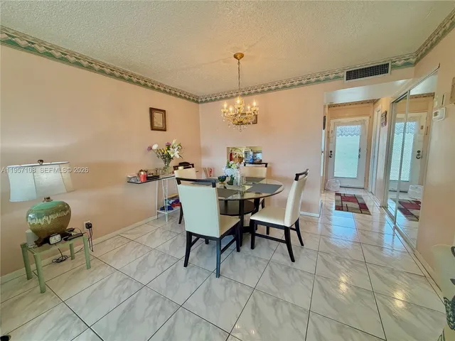 a view of a dining room with furniture and a window