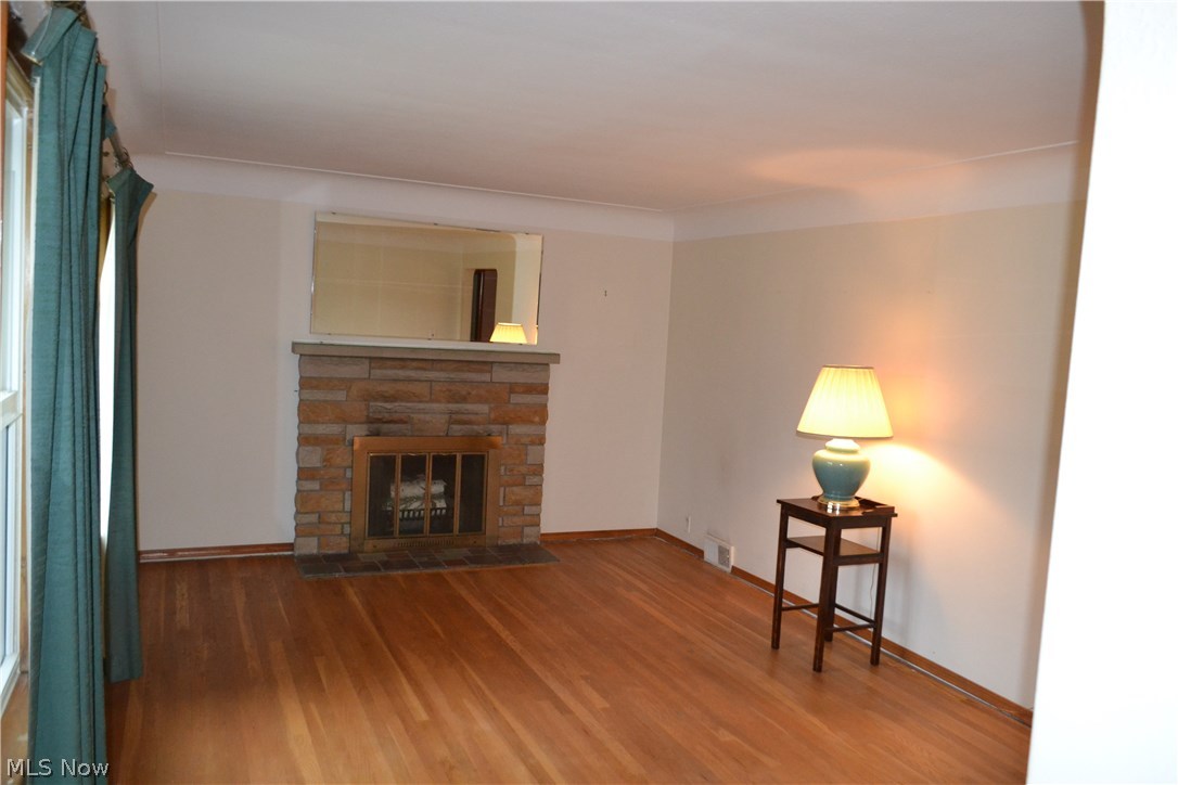 30049 Emery Road Chagrin Falls, OH 44022 - Photo 2 of 21 Living room has a wood burning fireplace and hardwood floors.