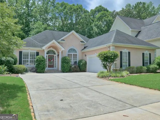 a front view of a house with garden