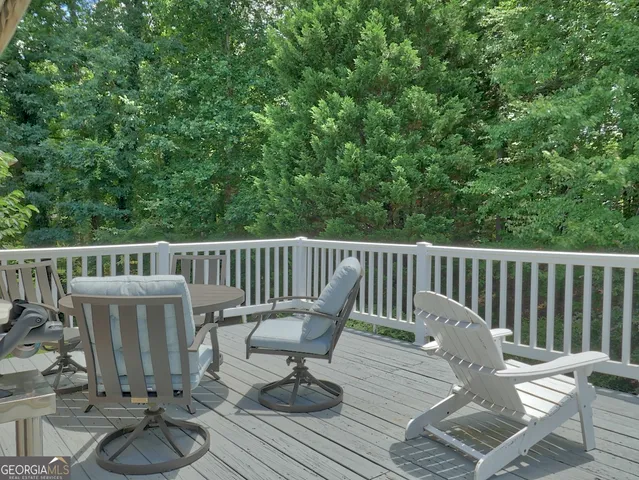 a view of balcony with wooden floor and outdoor seating