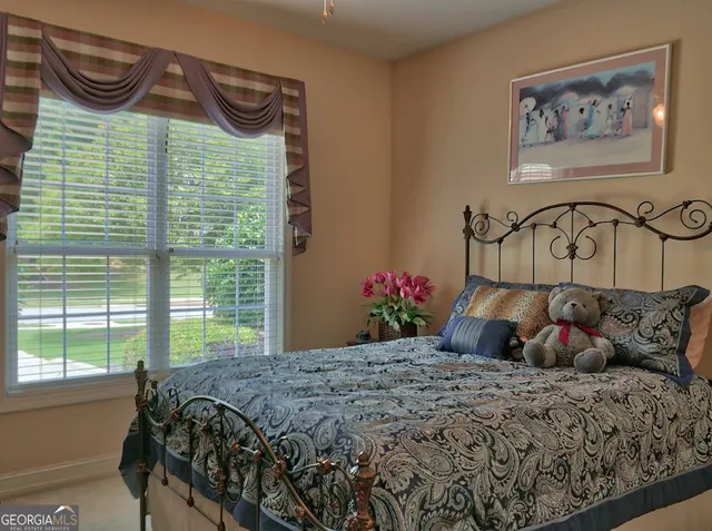 a bedroom with a bed and a painting on the wall