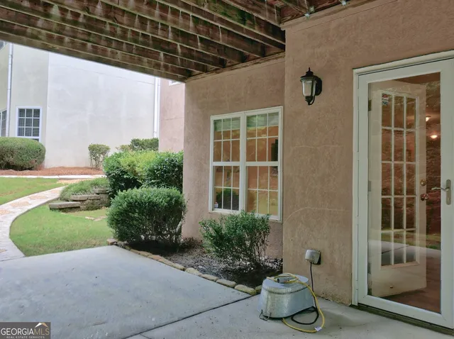 a front view of a house with potted plants