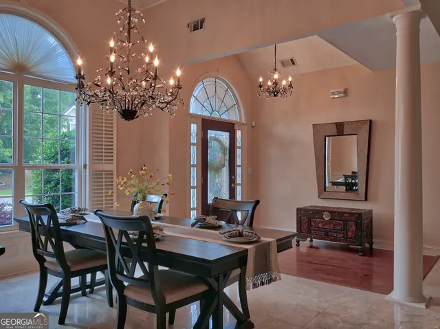 a view of a dining room with furniture wooden floor and chandelier