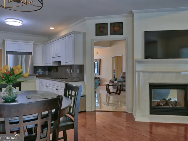 a kitchen with a fireplace a microwave a stove and cabinets