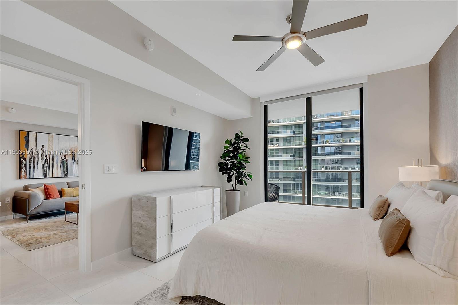 1010 Brickell Avenue, Unit 4309 Miami, FL 33131 - Photo 11 of 30 a bedroom with a large bed and a flat tv screen
