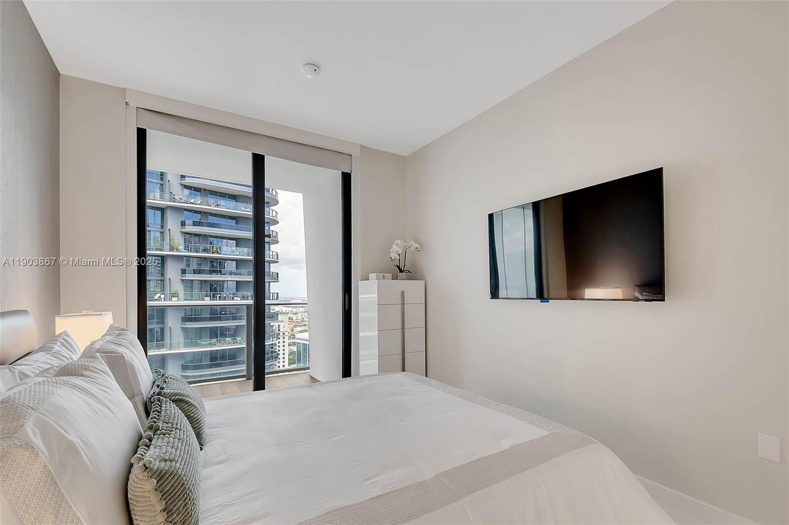 1010 Brickell Avenue, Unit 4309 Miami, FL 33131 - Photo 16 of 30 a bedroom with a bed and a flat screen tv