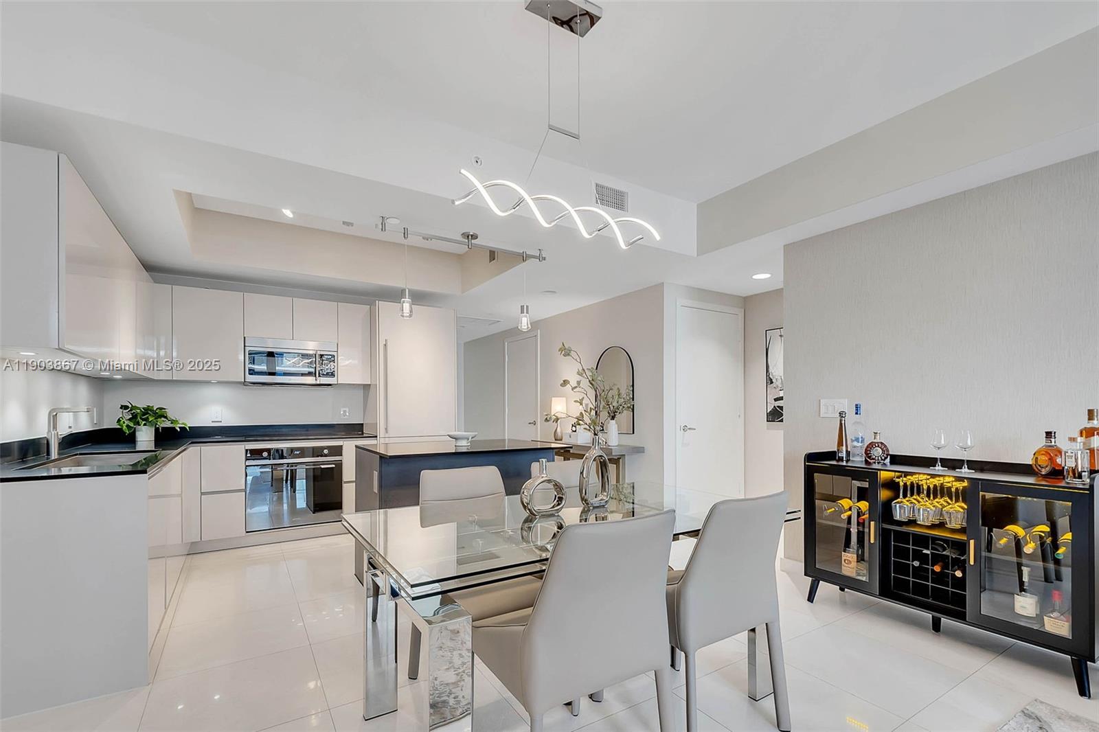 1010 Brickell Avenue, Unit 4309 Miami, FL 33131 - Photo 6 of 30 a kitchen with stainless steel appliances kitchen island granite countertop a table and chairs in it