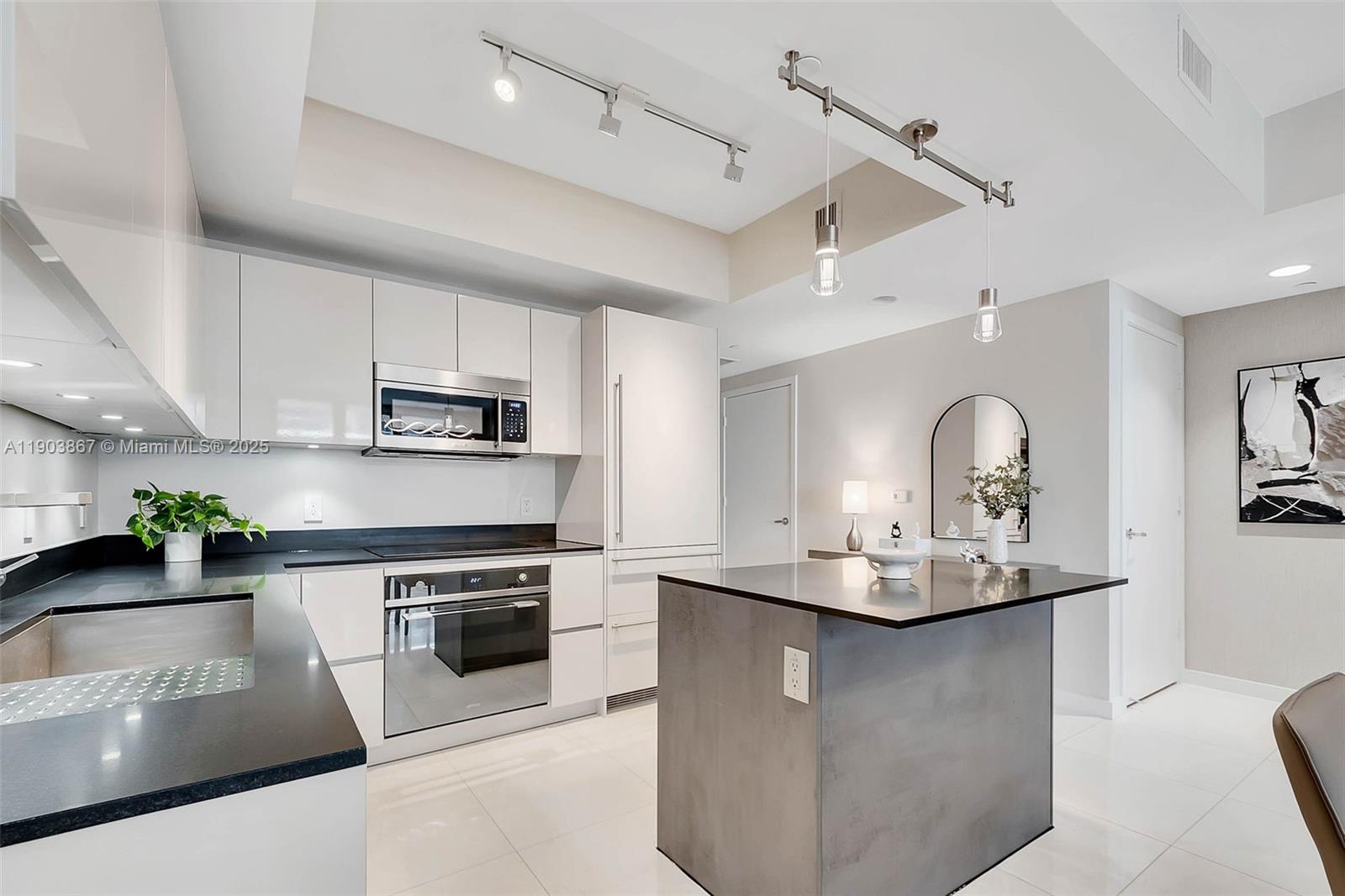 1010 Brickell Avenue, Unit 4309 Miami, FL 33131 - Photo 7 of 30 a kitchen with stainless steel appliances granite countertop a sink a stove and a refrigerator