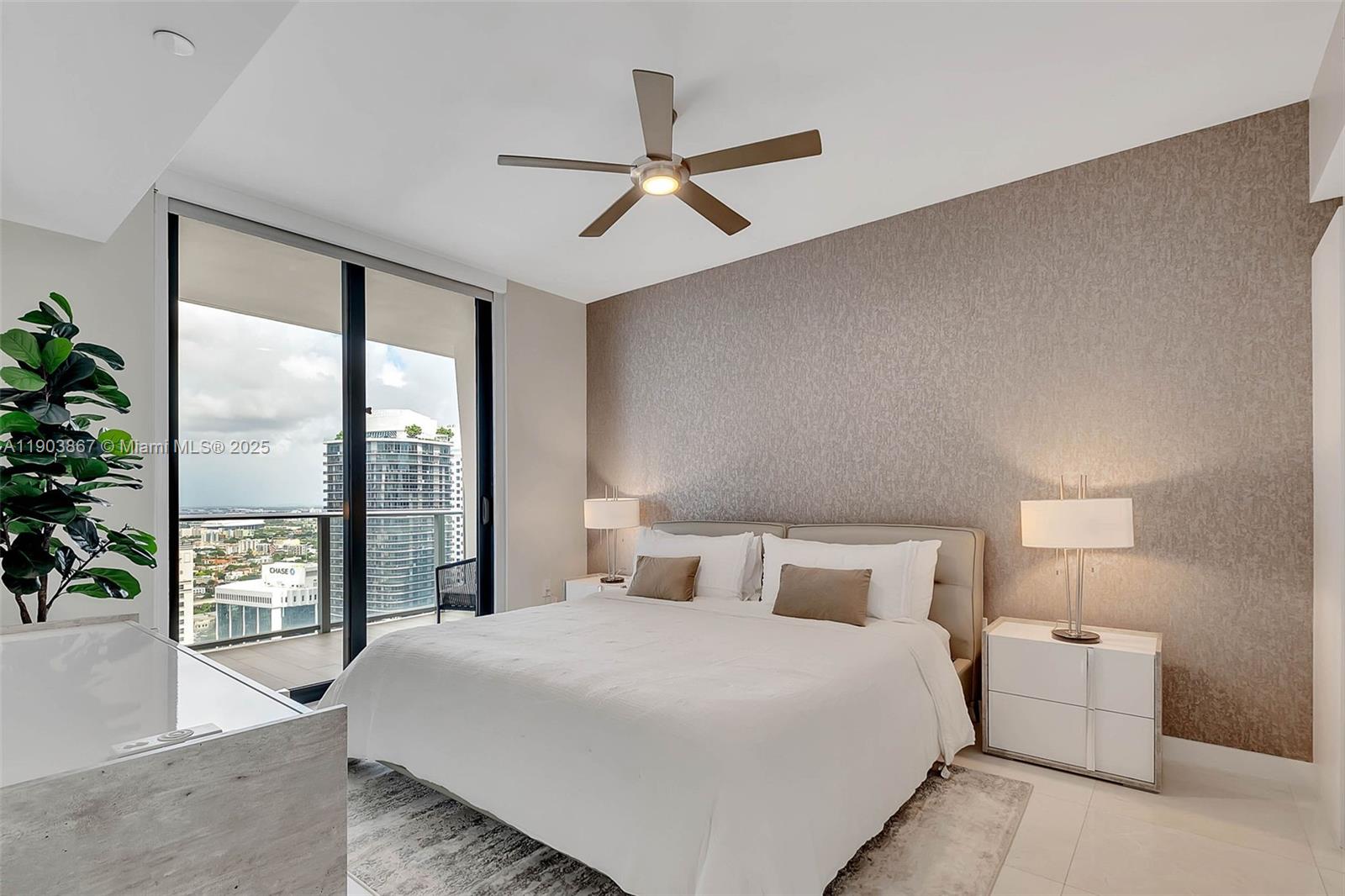 1010 Brickell Avenue, Unit 4309 Miami, FL 33131 - Photo 10 of 30 a bedroom with a large bed and a large window