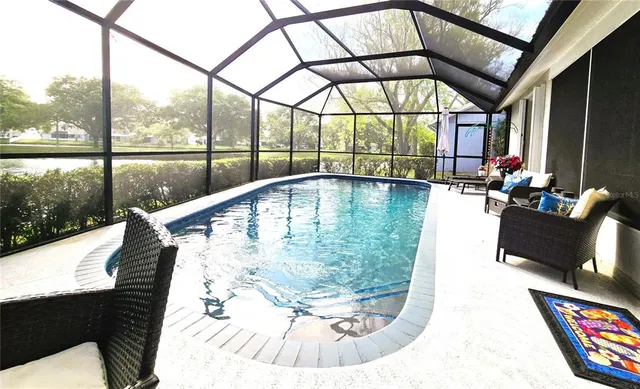 a view of swimming pool with seating space