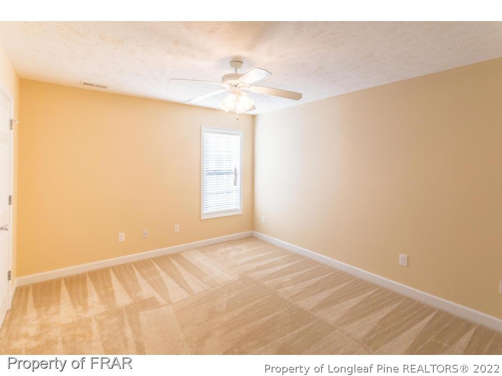 47 Rockingham Street Spring Lake, NC 28390 - Photo 21 of 27 a view of an empty room with window and a ceiling fan