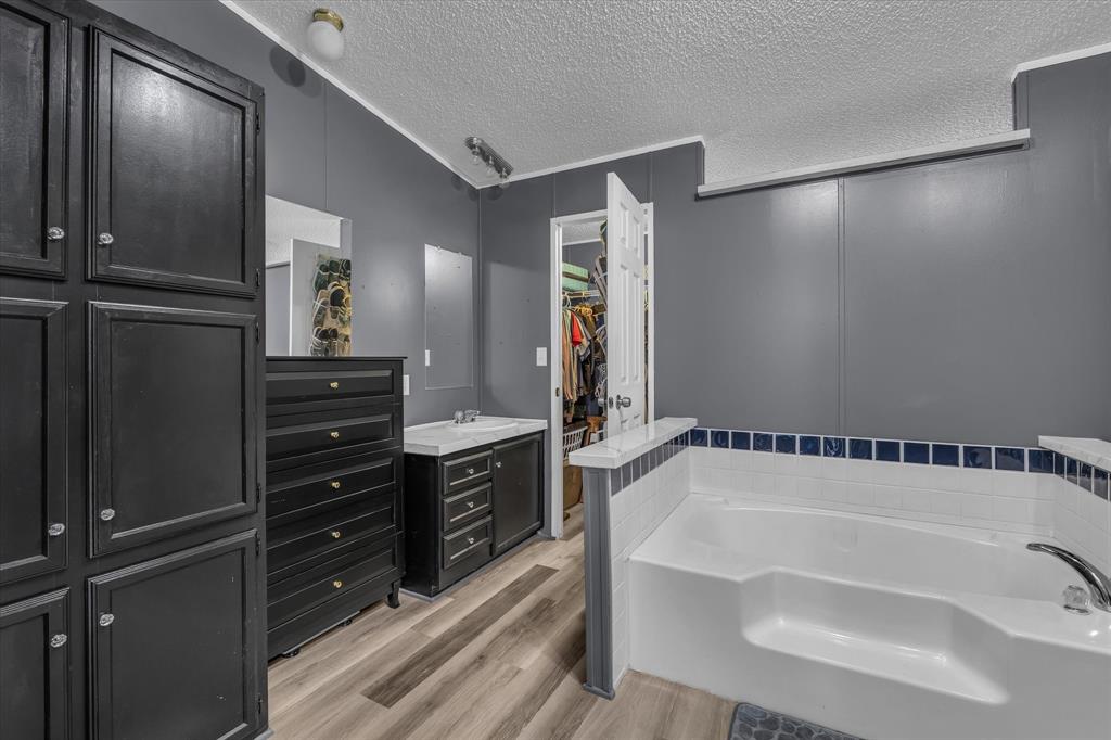 3615 Spring Valley Road Lorena, TX 76655 - Photo 24 of 33 Built-in soaking tub with white subway tile surround and decorative blue accent tiles