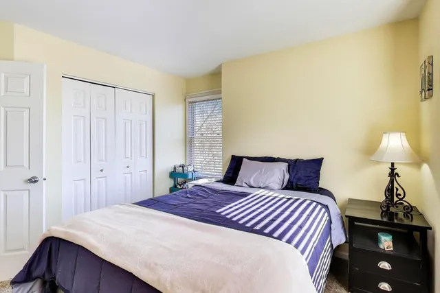 a bedroom with a bed and a lamp