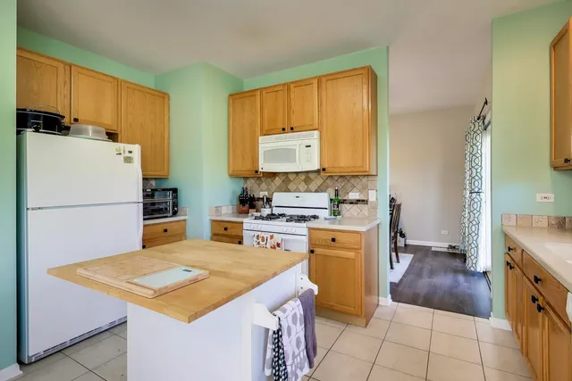 a kitchen with a refrigerator a stove top oven and a counter space