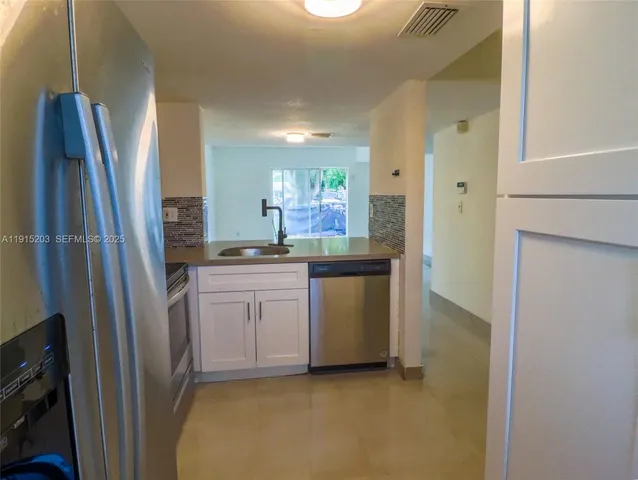 a kitchen with refrigerator and window