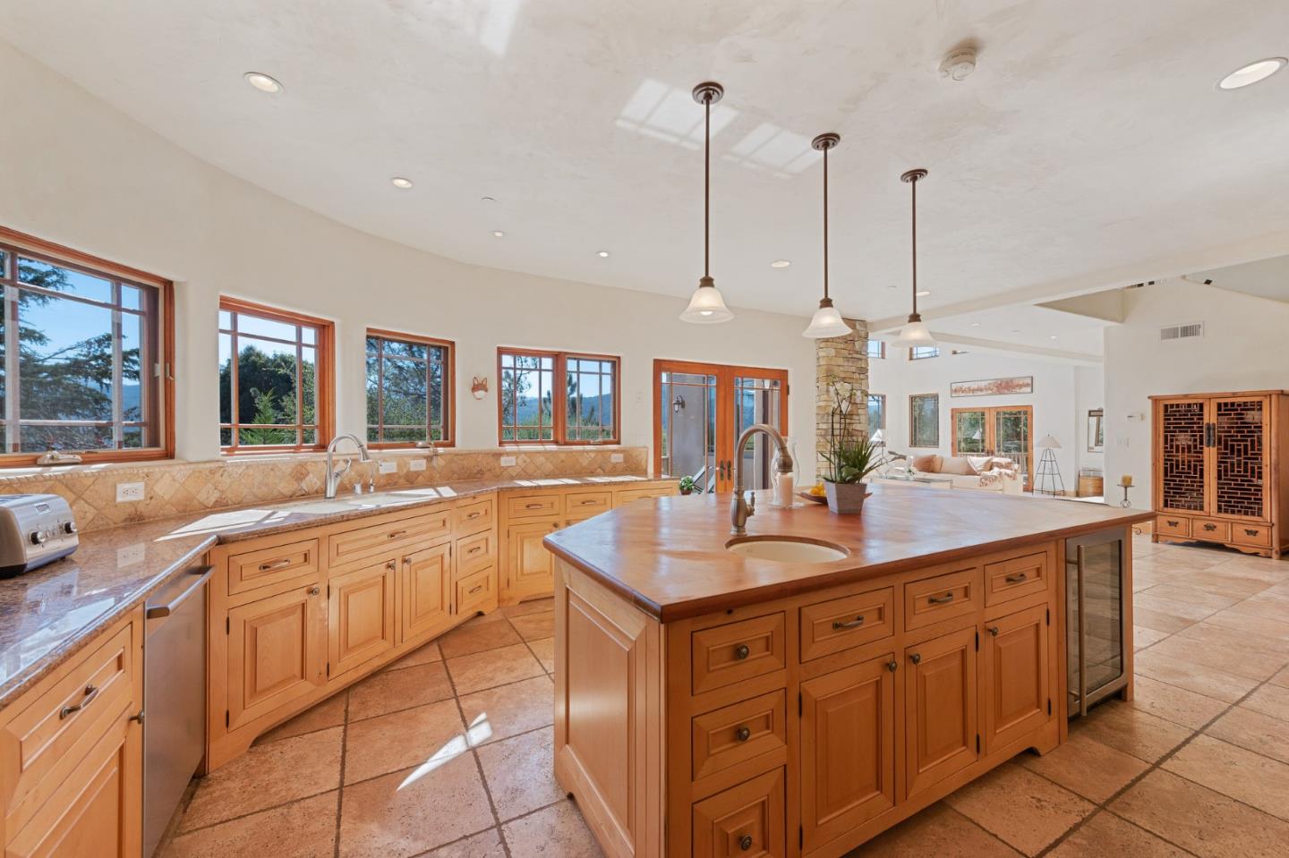 175 Chaparral Road Carmel Valley, CA 93924 - Photo 22 of 66 a kitchen with kitchen island granite countertop a sink and white cabinets