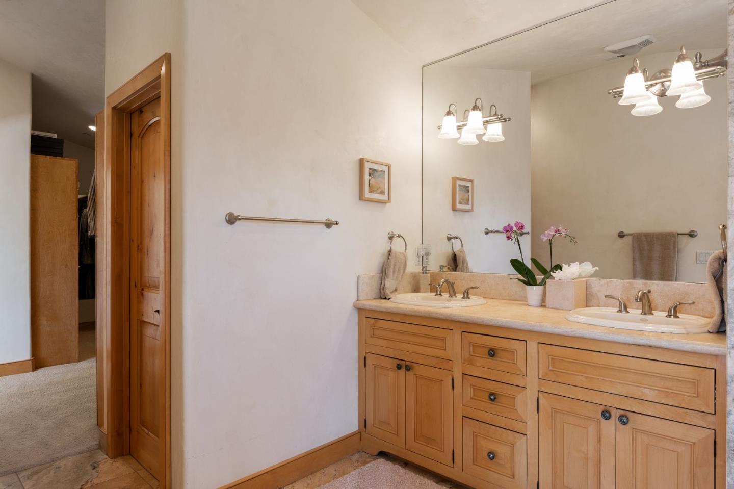 175 Chaparral Road Carmel Valley, CA 93924 - Photo 33 of 66 a en suite bathroom with a double vanity sink and a mirror