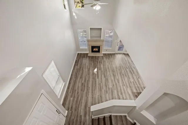 a view of a living room with furniture and wooden floor