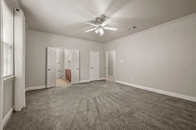 a view of an empty room with a ceiling fan