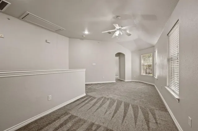 a view of empty room with ceiling fan