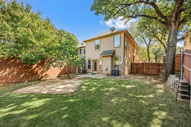 a house that has a tree in front of it