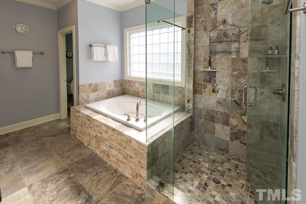 5021 Martin Farm Road Raleigh, NC 27613 - Photo 13 of 30 a bathroom with a bathtub and shower