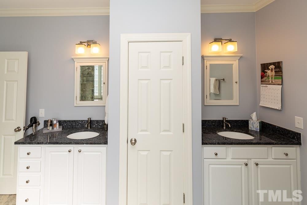 5021 Martin Farm Road Raleigh, NC 27613 - Photo 14 of 30 a bathroom with a sink and a mirror