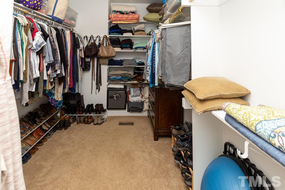 5021 Martin Farm Road Raleigh, NC 27613 - Photo 15 of 30 a view of walk in closet with clothes and shoes
