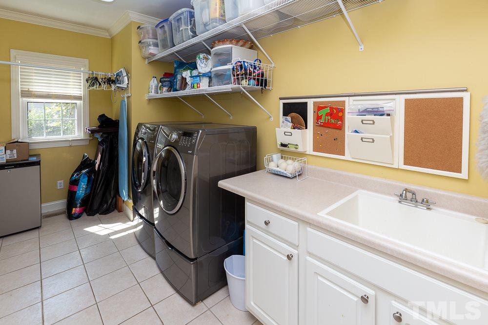 5021 Martin Farm Road Raleigh, NC 27613 - Photo 16 of 30 a utility room with dryer and washer