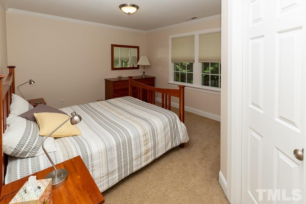 5021 Martin Farm Road Raleigh, NC 27613 - Photo 17 of 30 a bedroom with a bed and a window