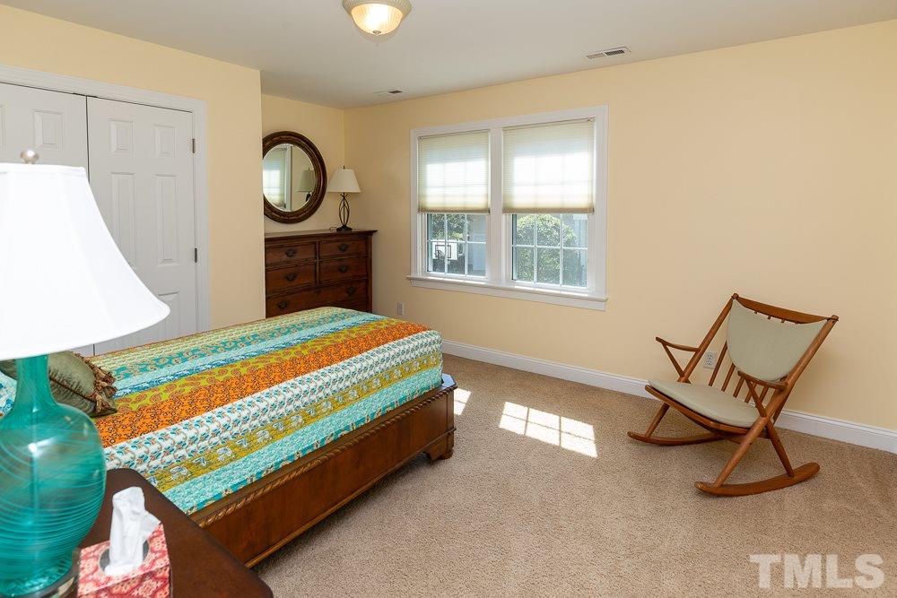 5021 Martin Farm Road Raleigh, NC 27613 - Photo 18 of 30 a bed sitting in a room next to a window