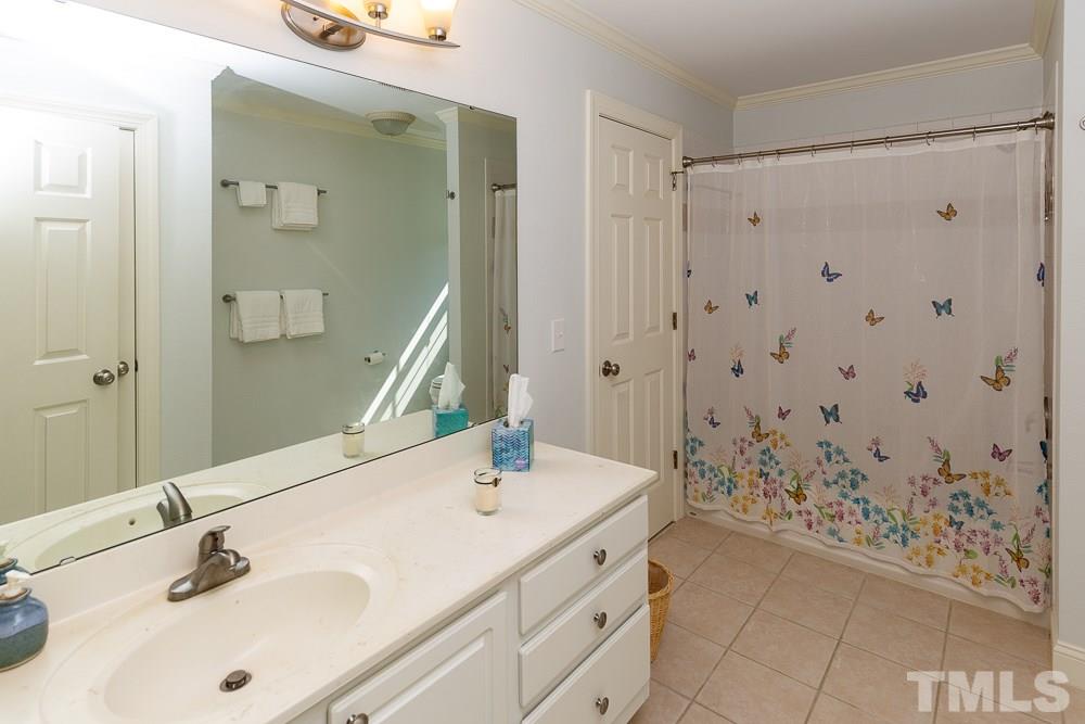 5021 Martin Farm Road Raleigh, NC 27613 - Photo 19 of 30 a bathroom with a sink and a mirror