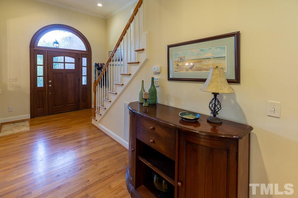 5021 Martin Farm Road Raleigh, NC 27613 - Photo 3 of 30 a view of entryway and hall with wooden floor