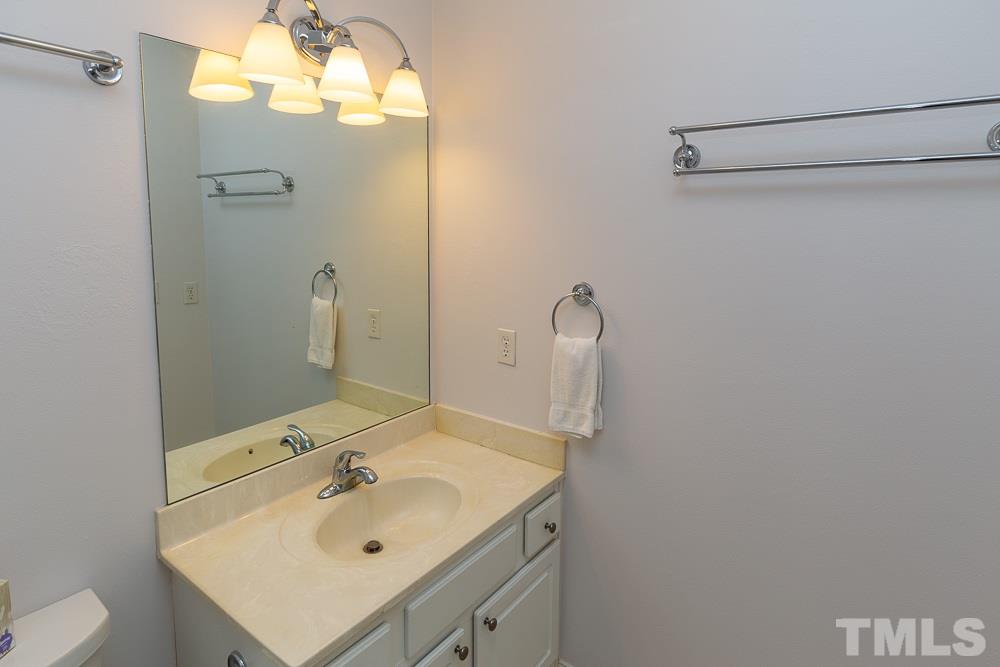 5021 Martin Farm Road Raleigh, NC 27613 - Photo 24 of 30 a bathroom with a sink and a mirror