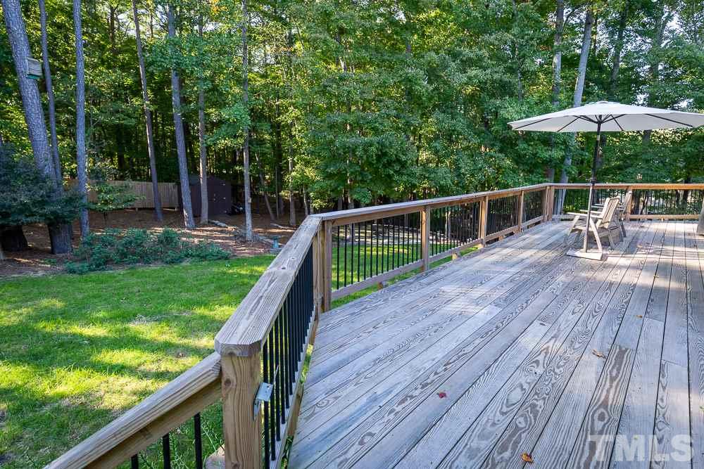 5021 Martin Farm Road Raleigh, NC 27613 - Photo 27 of 30 a balcony with wooden floor and outdoor seating