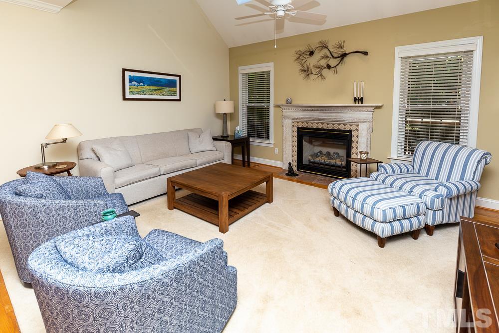 5021 Martin Farm Road Raleigh, NC 27613 - Photo 5 of 30 a living room with furniture and a fireplace