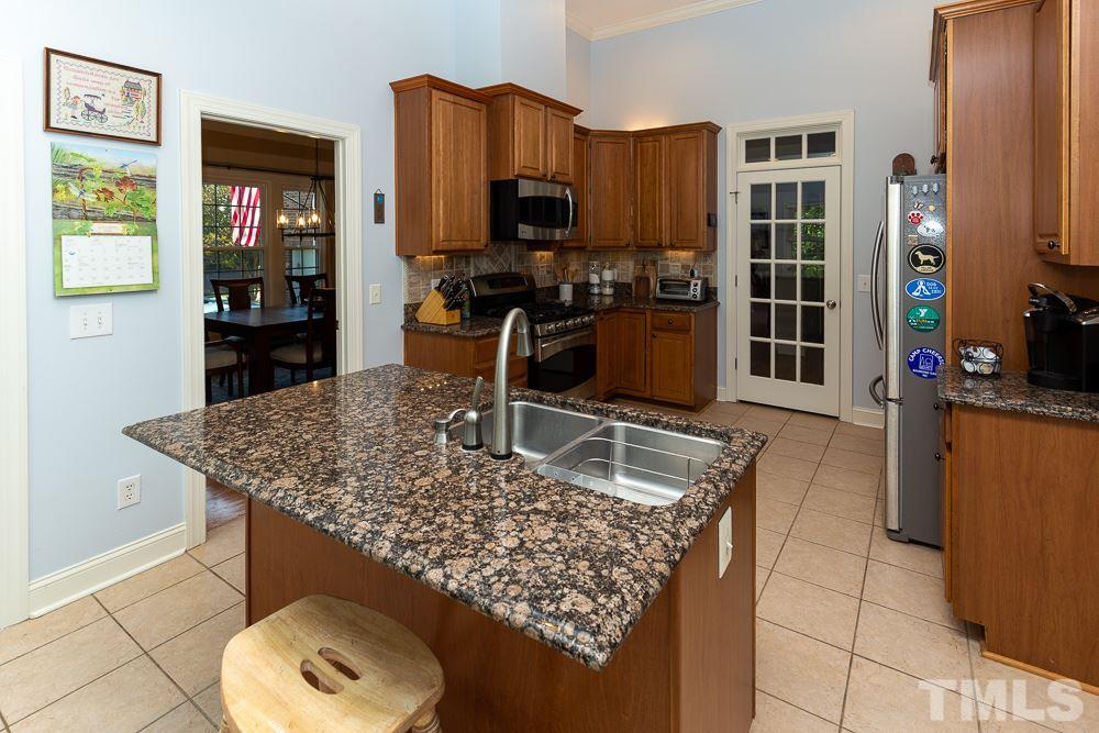 5021 Martin Farm Road Raleigh, NC 27613 - Photo 8 of 30 a kitchen with a table and chairs