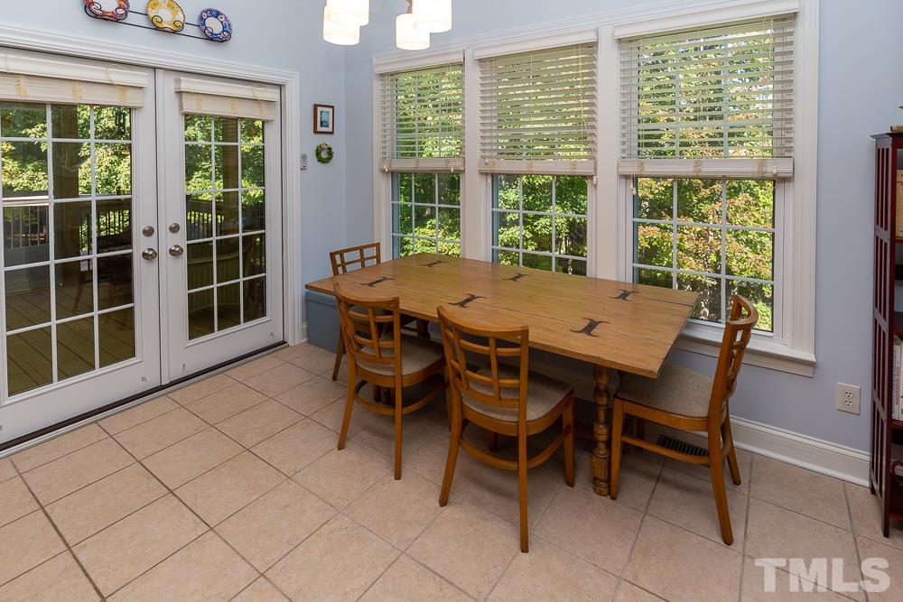 5021 Martin Farm Road Raleigh, NC 27613 - Photo 10 of 30 a view of a dining room with furniture and a window