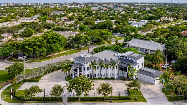 an aerial view of residential houses with outdoor space and street view