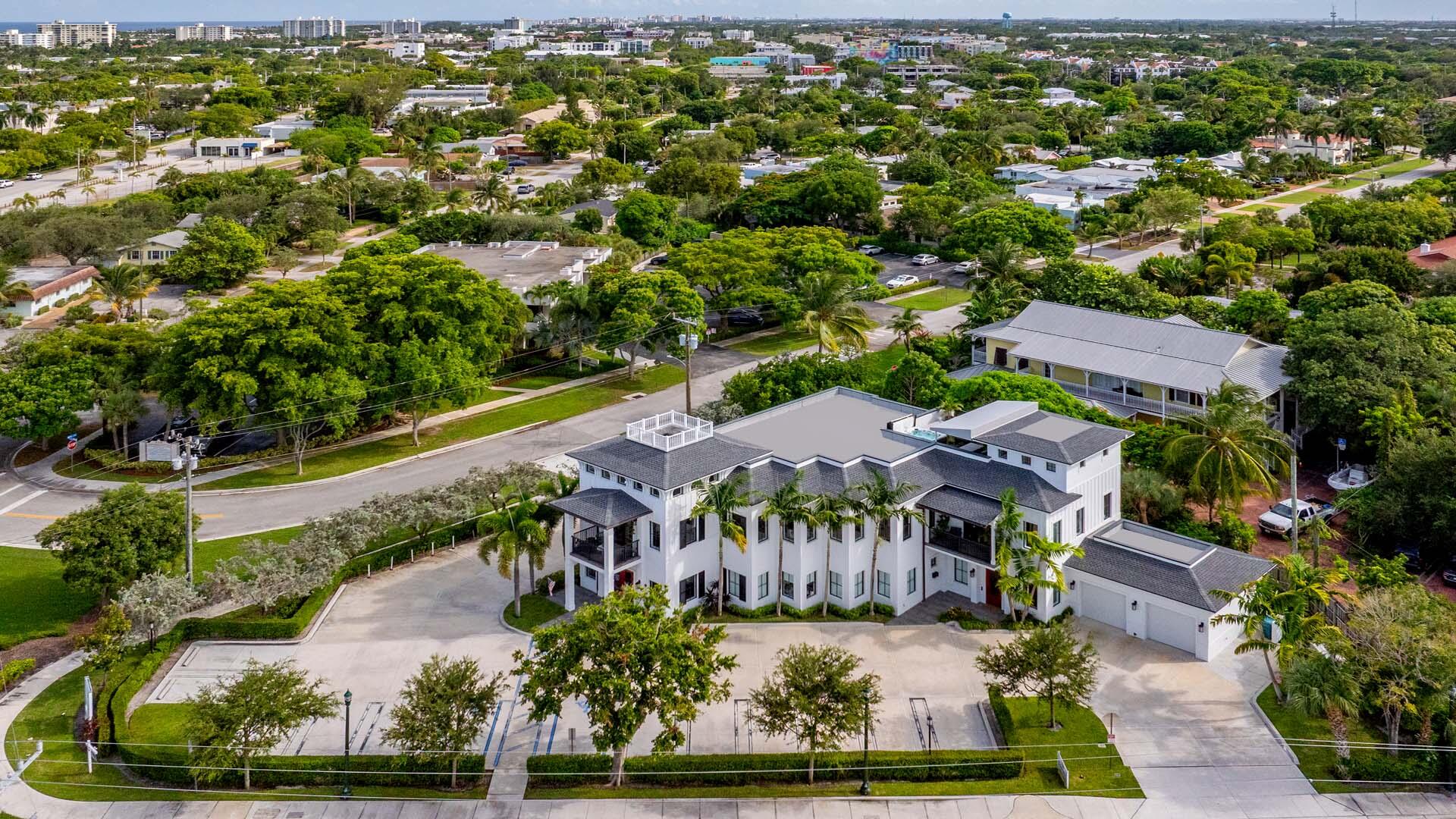 an aerial view of residential houses with outdoor space and street view