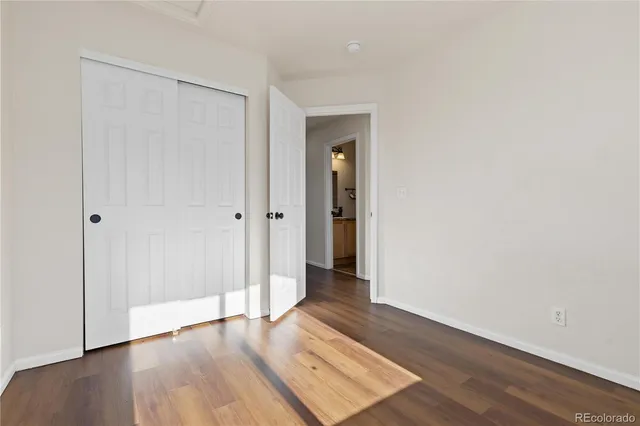 wooden floor in a hall with an empty room