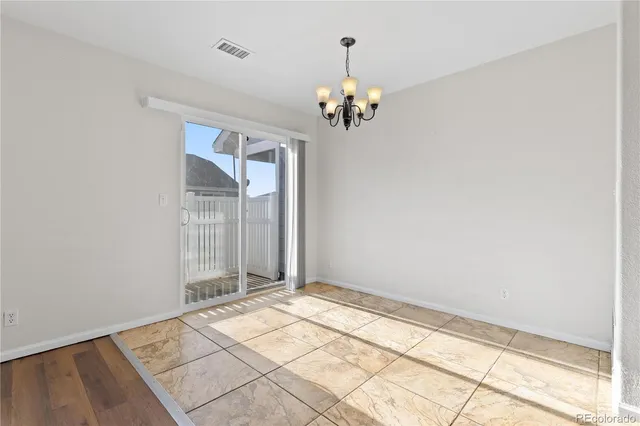 a view of a room with a chandelier fan and windows