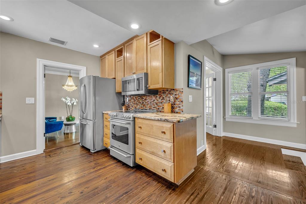 1960 Winter Park Road Winter Park, FL 32789 - Photo 21 of 46 a kitchen with white cabinets and wooden floors