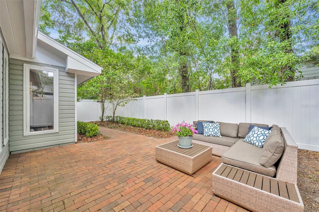 1960 Winter Park Road Winter Park, FL 32789 - Photo 31 of 46 a view of a patio with couches and table and chairs with wooden floor and fence